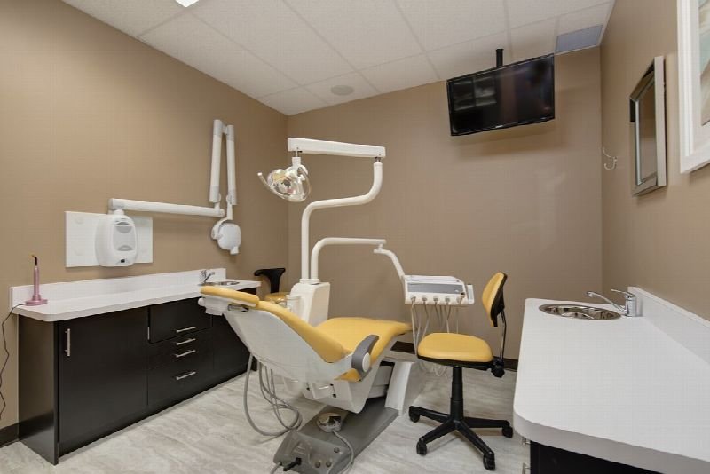 Dental treatment room with a patient chair and overhead light