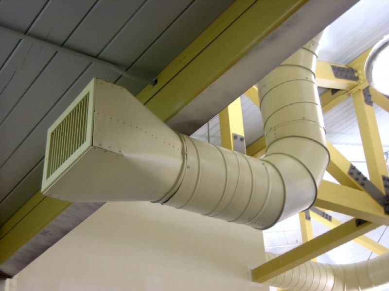 Exposed ventilation ductwork running along a ceiling