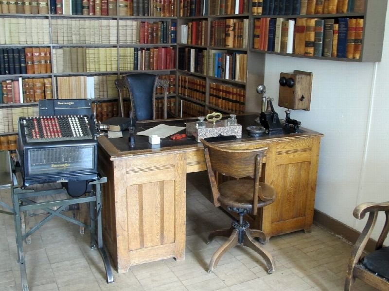 Traditional law office interior with bookshelves, desk and typewriter