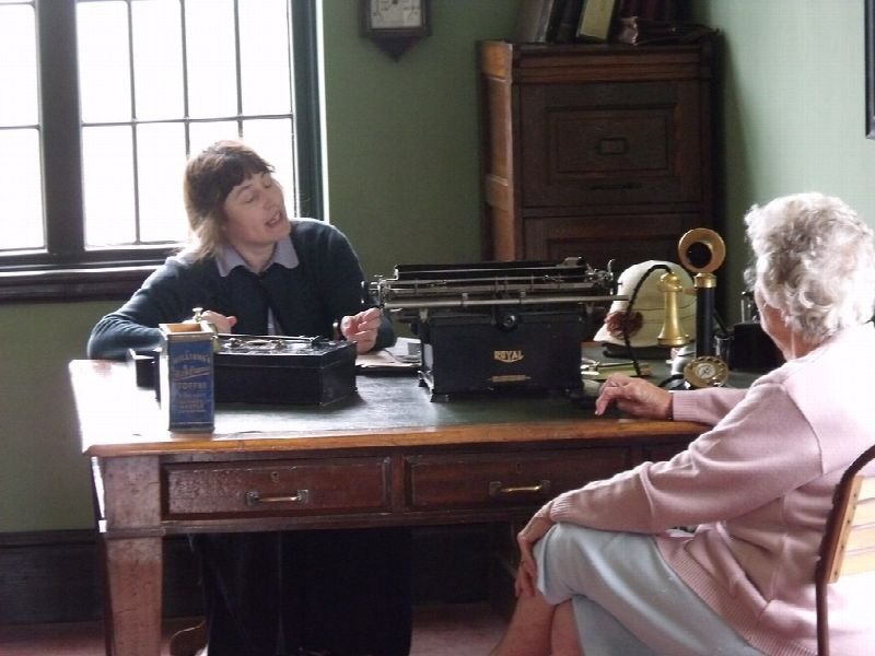 Office workers at a desk with paperwork