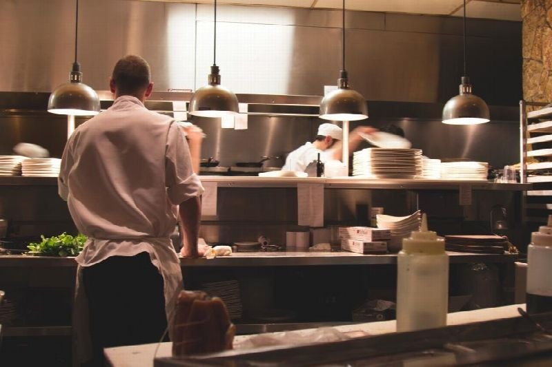 Chef cooking in a busy restaurant kitchen